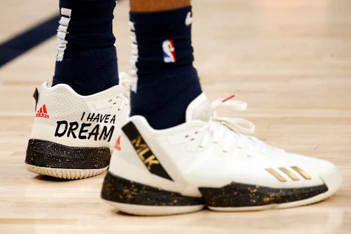 View of white and black adidas shoes.